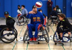 Harlem Globetrotters' Orlando "El Gato" Melendez passes the ball during a game of wheelchair basketball with students at Martin Luther King Middle School in Berkeley, Calif., on Tuesday, Jan. 12, 2016. The appearance allowed non-disabled children the opportunity to learn about wheelchair basketball with the world famous Harlem Globetrotters who are in town for a series of seven Bay Area performances. (Kristopher Skinner/Bay Area News Group)